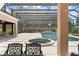 Screened-in pool area featuring a pool, spa, covered lanai, and outdoor dining space at 10915 Emerald Chase Dr, Orlando, FL 32836