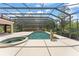 Beautiful pool area with screened enclosure, a spa, and lush landscaping at 10915 Emerald Chase Dr, Orlando, FL 32836