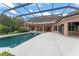 An exterior shot of the pool, patio, and home showcasing a large backyard pool area for entertaining at 10915 Emerald Chase Dr, Orlando, FL 32836