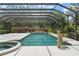 Large pool in screened enclosure with a hot tub, lush landscaping, and a pool lift at 10915 Emerald Chase Dr, Orlando, FL 32836