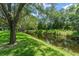 Scenic waterfront view with lush greenery, canal access, and a charming boat dock for recreational activities at 10915 Emerald Chase Dr, Orlando, FL 32836