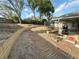 Landscaped backyard featuring a trampoline and wooden retaining wall at 1140 Odoniel S Loop, Lakeland, FL 33809