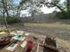 A backyard with newly installed retaining wall, some plants and a wheelbarrow at 1140 Odoniel S Loop, Lakeland, FL 33809
