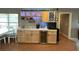 Stylish bar area featuring custom cabinets, countertop space, and wine storage at 1140 Odoniel S Loop, Lakeland, FL 33809