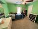 Bright green bedroom featuring a ceiling fan and a bed with blue covers at 1140 Odoniel S Loop, Lakeland, FL 33809