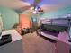 This bedroom features bright teal walls, a ceiling fan, and a bunk bed at 1140 Odoniel S Loop, Lakeland, FL 33809