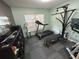 Home gym featuring exercise equipment, weight machines, and rubber flooring, perfect for fitness enthusiasts at 1140 Odoniel S Loop, Lakeland, FL 33809