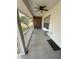 Inviting covered front porch featuring a ceiling fan, swing, and a 'Welcome' mat at 1140 Odoniel S Loop, Lakeland, FL 33809