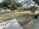 Well-maintained front yard with mature trees and a neatly kept lawn, creating a welcoming curb appeal at 1140 Odoniel S Loop, Lakeland, FL 33809