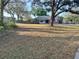 Spacious front yard with mature trees surrounding a well-kept single-story brick home at 1140 Odoniel S Loop, Lakeland, FL 33809