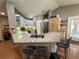Spacious kitchen featuring granite countertops, stainless steel appliances, a breakfast bar, and tile flooring at 1140 Odoniel S Loop, Lakeland, FL 33809