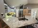 Stylish kitchen with granite countertops, stainless steel appliances, tiled flooring, and barstool seating at 1140 Odoniel S Loop, Lakeland, FL 33809
