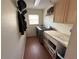A laundry room features a washer, dryer, folding counter, and storage at 1140 Odoniel S Loop, Lakeland, FL 33809