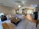 Open-concept living room flows into the kitchen with ample seating and neutral tones at 1140 Odoniel S Loop, Lakeland, FL 33809