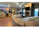 Bright living room with a fireplace, sectional sofa, and a bar area near the kitchen at 1140 Odoniel S Loop, Lakeland, FL 33809