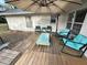 A patio features cushioned outdoor seating, a wooden deck, and shade at 1140 Odoniel S Loop, Lakeland, FL 33809