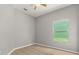 Bedroom offers laminate flooring and a window with a lush green view at 13658 Hidden Forest Cir, Orlando, FL 32828
