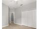 Cozy bedroom features a ceiling fan, closet, and light laminate flooring at 13658 Hidden Forest Cir, Orlando, FL 32828