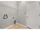 Simple laundry room with tile flooring, wire shelving, and washer-dryer hookups at 13658 Hidden Forest Cir, Orlando, FL 32828