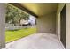 Covered patio with a view of the green lawn and white picket fence at 13658 Hidden Forest Cir, Orlando, FL 32828