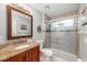 Bathroom features a granite-topped vanity, updated fixtures, and a shower over tub at 14301 Bending Branch Ct, Orlando, FL 32824