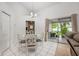 Open dining area with white table set, sliding glass doors leading to the backyard, and tile flooring at 14301 Bending Branch Ct, Orlando, FL 32824