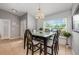 Bright dining area with a modern chandelier, stylish table set, and large window offering natural light at 14301 Bending Branch Ct, Orlando, FL 32824