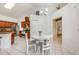 Bright kitchen dining area with white table set, stainless steel appliances and cherry colored wood cabinets at 14301 Bending Branch Ct, Orlando, FL 32824