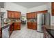 Open kitchen concept with stainless steel appliances, granite countertops, tile backsplash, and white tile flooring at 14301 Bending Branch Ct, Orlando, FL 32824