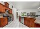 Spacious open concept kitchen with stainless steel appliances, granite countertops, and breakfast bar seating at 14301 Bending Branch Ct, Orlando, FL 32824