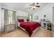 Comfortable main bedroom with tile floors, neutral decor, ceiling fan, and lots of natural light at 14301 Bending Branch Ct, Orlando, FL 32824