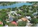 An aerial view of a lakeside neighborhood showcasing lush greenery and a variety of single-Gathering homes, some with pools at 1481 Glastonberry Rd, Maitland, FL 32751