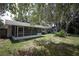 Backyard view of the house and its large, covered, screened-in patio at 1481 Glastonberry Rd, Maitland, FL 32751