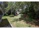 Spacious backyard featuring a wood fence, mature trees, and lush landscaping at 1481 Glastonberry Rd, Maitland, FL 32751