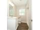 Bright bathroom featuring a modern vanity, wood-look flooring, and accessible toilet at 1481 Glastonberry Rd, Maitland, FL 32751