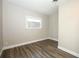 Cozy bedroom featuring wood-style laminate floors and bright natural light at 1481 Glastonberry Rd, Maitland, FL 32751