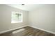 Bedroom with wood-style laminate flooring and a bright, sunlit window at 1481 Glastonberry Rd, Maitland, FL 32751