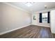 Bright bedroom featuring wood floors, a window, and access to an exterior door at 1481 Glastonberry Rd, Maitland, FL 32751