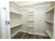 Walk-in closet with built-in shelving and wood-style laminate flooring at 1481 Glastonberry Rd, Maitland, FL 32751