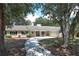 Charming single-story home with mature trees and a welcoming entrance at 1481 Glastonberry Rd, Maitland, FL 32751