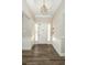 Entryway with modern light fixture, wainscoting, and wood-look flooring at 1481 Glastonberry Rd, Maitland, FL 32751