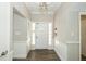 Bright foyer featuring modern lighting, wood-look floors, and wainscoting at 1481 Glastonberry Rd, Maitland, FL 32751