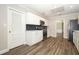 Modern kitchen with stainless appliances, white cabinetry, subway tile backsplash and wood-look floors at 1481 Glastonberry Rd, Maitland, FL 32751