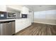 Updated kitchen with white cabinets, stainless steel appliances, and wood-look floors at 1481 Glastonberry Rd, Maitland, FL 32751