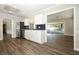 Renovated kitchen with stainless steel appliances, white cabinets, and an open layout to the living area at 1481 Glastonberry Rd, Maitland, FL 32751