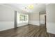 Bright living room featuring a large window, wood-look floors, and neutral paint at 1481 Glastonberry Rd, Maitland, FL 32751