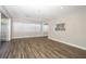 Bright living room with wood floors, view into another room, and white window treatments at 1481 Glastonberry Rd, Maitland, FL 32751