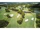 Scenic aerial image highlighting a beautiful golf course with trees, sand traps and water hazards at 1769 Turnberry Ter, Orlando, FL 32804
