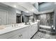 Modern bathroom featuring a double vanity, marble tile, and a soaking tub at 1769 Turnberry Ter, Orlando, FL 32804