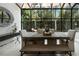 Sunlit dining room with a large window, natural wood table, bench seating, and neutral decor at 1769 Turnberry Ter, Orlando, FL 32804